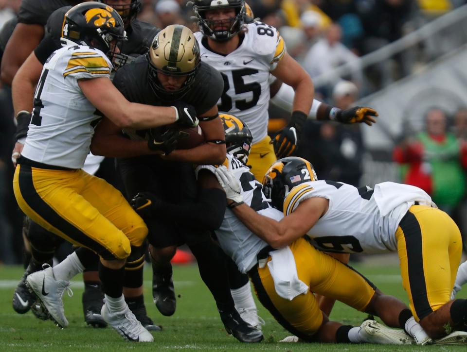 Purdue Boilermakers running back Devin Mockobee (45) is tackled by a group of Iowa Hawkeyes during the NCAA football game, Saturday, Nov. 5, 2022, at Ross-Ade Stadium in West Lafayette, Ind. Iowa won 24-3.