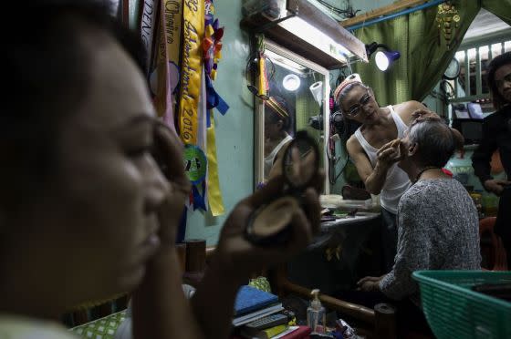Federico ‘Rica‘ Ramasamy (back right), who has since passed away, looks in a mirror as a fellow Golden Gays member applies makeup on her before a drag pageant in Manila, June 16, 2018.<span class="copyright">Noel Celis—AFP/Getty Images</span>