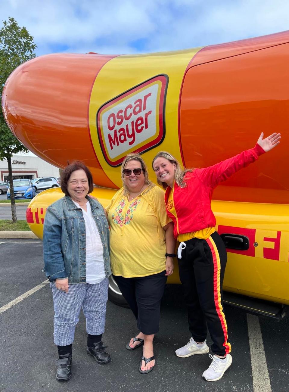 Anna Murphy-Pociask, on the marketing team at Oscar Mayer, is shown with two Youngstown area residents who posed for a photo with the Frankmobile. The unique vehicle will be in downtown Canton today during a Northeast Ohio tour.