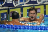 Nathan Adrian congratulates Caeleb Dressel after the men's 50 freestyle during wave 2 of the U.S. Olympic Swim Trials on Saturday, June 19, 2021, in Omaha, Neb. (AP Photo/Jeff Roberson)