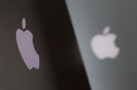 Apple company logos are seen as two MacBooks stand next to each other in an office in Vienna, Austria January 3, 2019. REUTERS/Leonhard Foeger