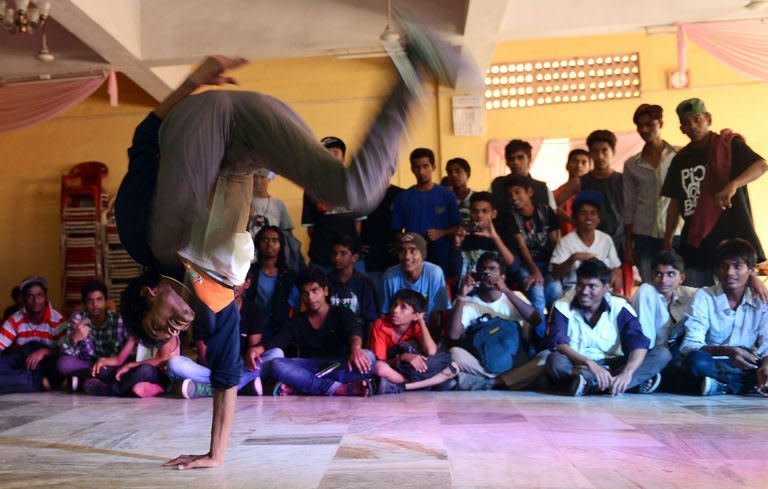 A dancer performs in a competition organised by the SlumGods, a group of b-boy dancers, in Mumbai on November 25, 2012. The SlumGods have inspired hundreds of urban Indian youngsters to try their hands at b-boying, a cheap and funky combination of exercise and self-expression