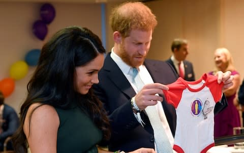 The Duke and Duchess of Sussex admire a gift for their son Archie - Credit: WPA pool