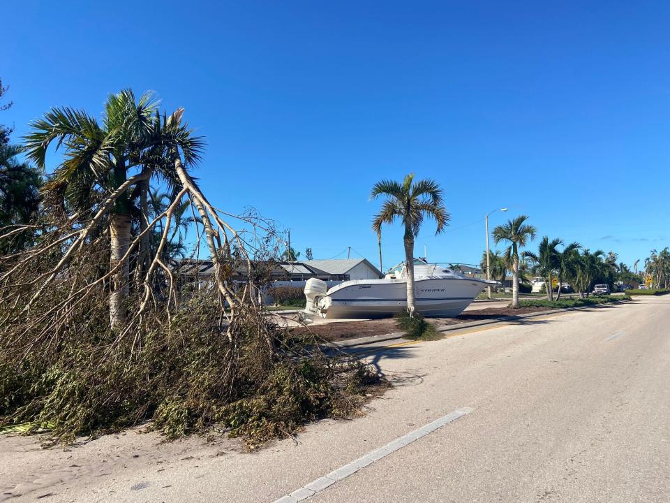 A stranded boat stuck on a median on Beach Parkway driving towards the Cape Coral Yacht Club.