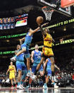 Atlanta Hawks forward John Collins, right, goes in for a layup during the first half of an NBA basketball game against the Charlotte Hornets, Sunday, Dec. 5, 2021, in Atlanta. (AP Photo/Edward M. Pio Roda)