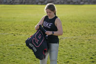 Sam Gordon puts on her shoulder pads, Oct. 20, 2020, in Herriman, Utah. Gordon was the only girl in a tackle football league when she started playing the game at age 9. Now, Gordon hopes she can give girls a chance to play on female-only high school teams through a lawsuit. (AP Photo/Rick Bowmer)