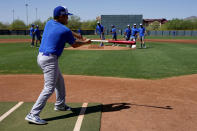 Israel Olympic Baseball team assistant coach Nate Mulberg hits grounders to pitchers during practice at Salt River Fields, Wednesday, May 12, 2021, in Scottsdale, Ariz. Israel has qualified for the six-team baseball tournament at the Tokyo Olympic games which will be its first appearance at the Olympics in any team sport since 1976. (AP Photo/Matt York)