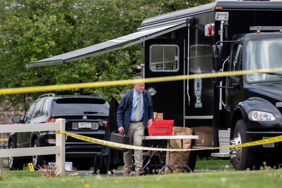 Investigators work on the scene of an Upper Makefield home where two boys, 10 and 13 years old, were shot Monday morning. Their mother, 38-year-old Trinh Nguyen, was arrested and charged in the shooting, according to Bucks County District Attorney Matthew Weintraub.