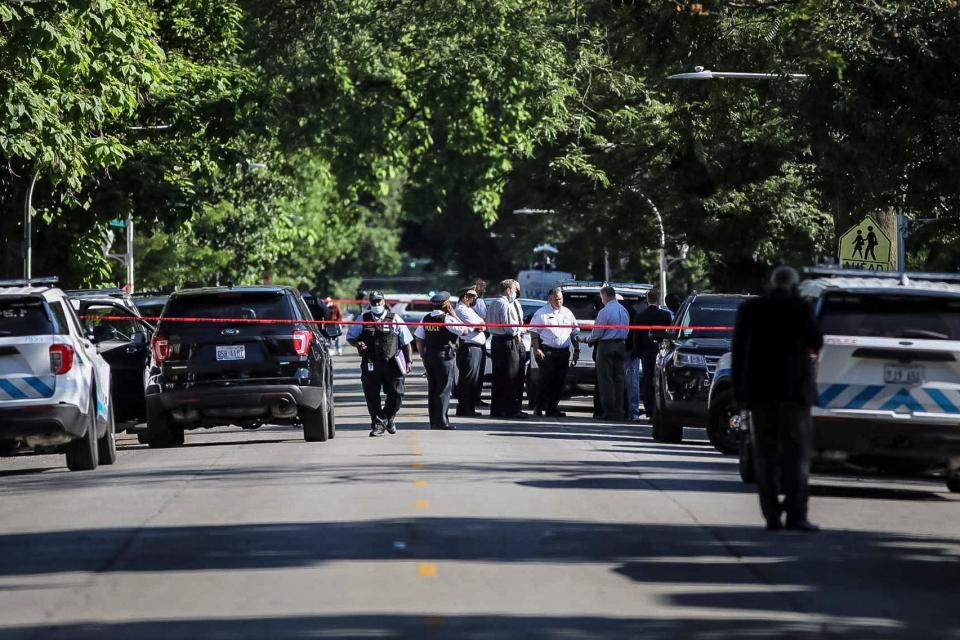 Police investigate the scene of a shooting outside a home in Chicago, Tuesday, June 15, 2021.  Police say an argument at a house on Chicago's South Side erupted in fatal gunfire, leaving some dead and others injured.