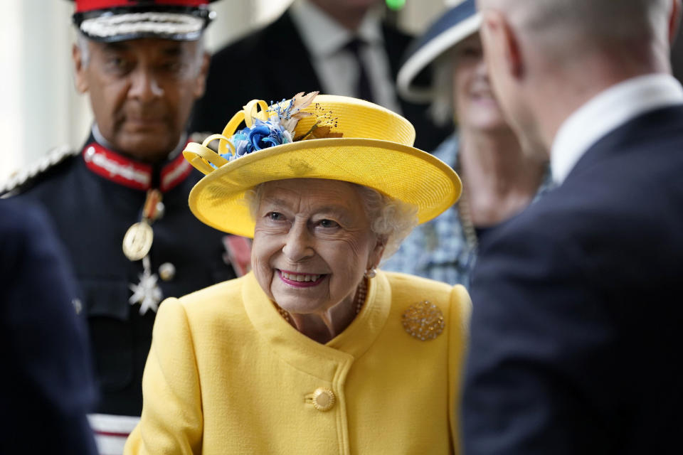 Britain's Queen Elizabeth II meets staff who have been key to the Crossrail project, as well as Elizabeth Line staff who will be running the railway, including apprentices, drivers, and station staff at Paddington station in London, to mark the completion of London's Crossrail project, Tuesday, May 17, 2022. (Andrew Matthews/PA via AP)