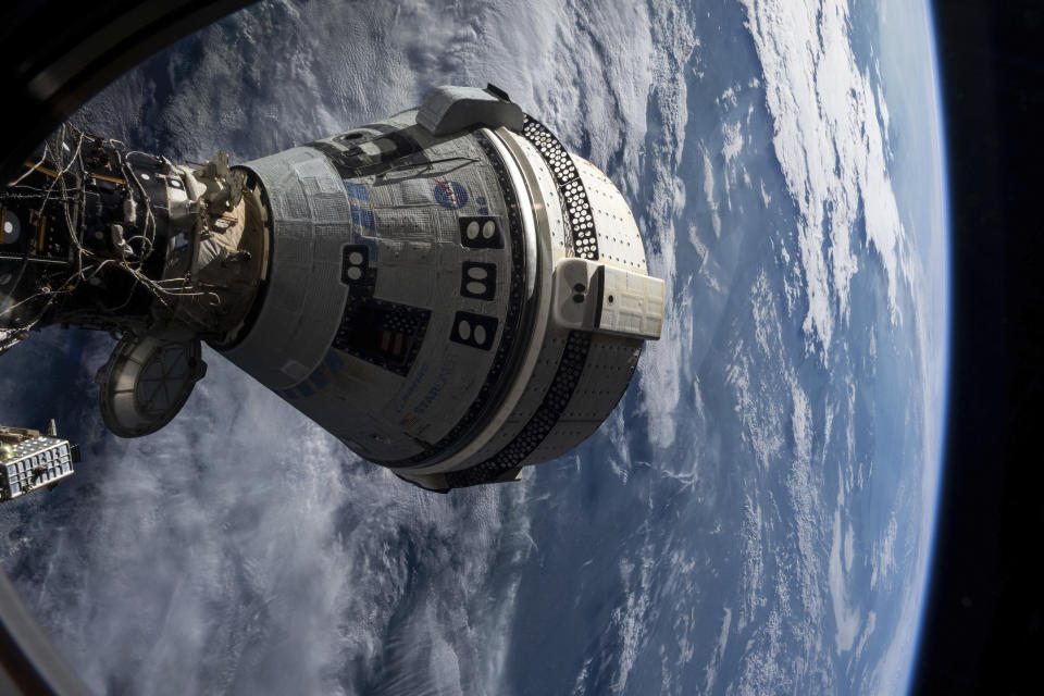 In this photo provided by NASA, Boeing's Starliner spacecraft is docked to the Harmony module of the International Space Station on July 3, 2024, seen from a window on the SpaceX Dragon Endeavour spacecraft docked to an adjacent port. (NASA via AP)