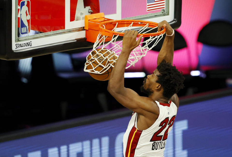 Miami Heat's Jimmy Butler dunks against the Denver Nuggets during an NBA basketball game, Saturday, Aug. 1, 2020, in Lake Buena Vista, Fla. (Kevin C. Cox/Pool Photo via AP)