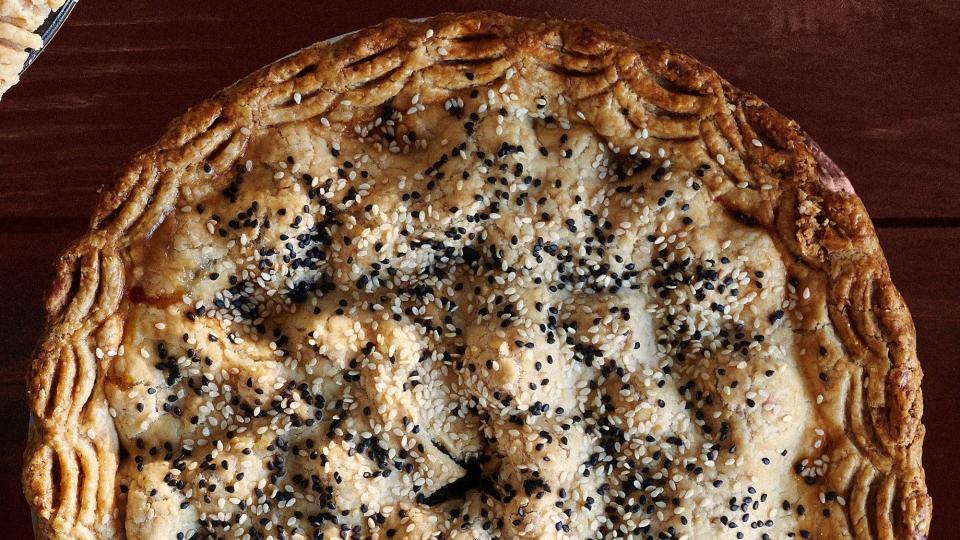 pear date and sesame pie with a double crust and sesame seeds on top