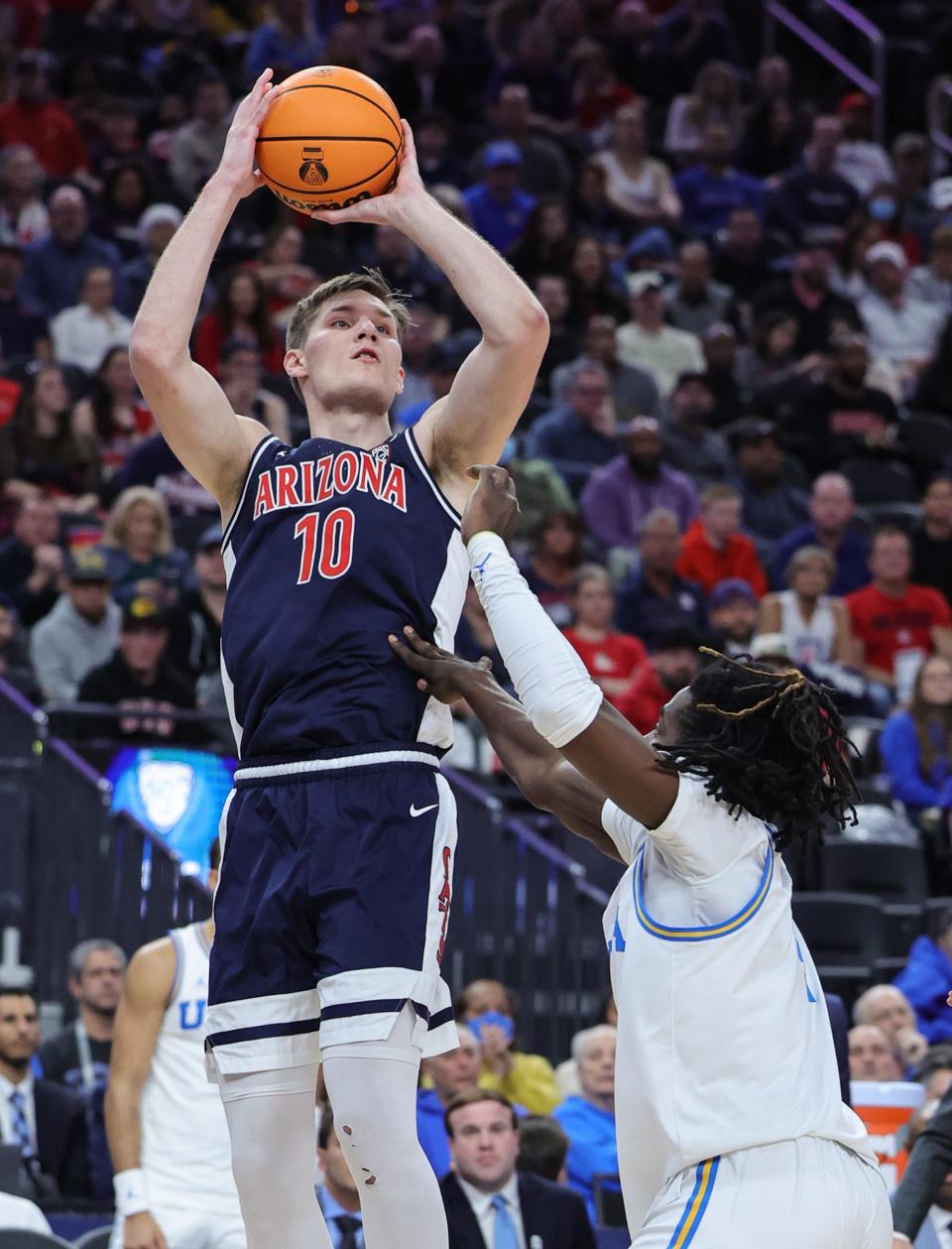 Azuolas Tubelis #10 of the Arizona Wildcats shoots against Will McClendon #4 of the UCLA Bruins in the first half of the championship game of the Pac-12 basketball tournament at T-Mobile Arena on March 11, 2023, in Las Vegas, Nevada.