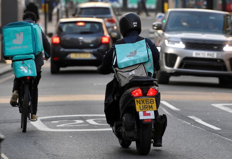 FILE PHOTO: Deliveroo delivery workers ride in London