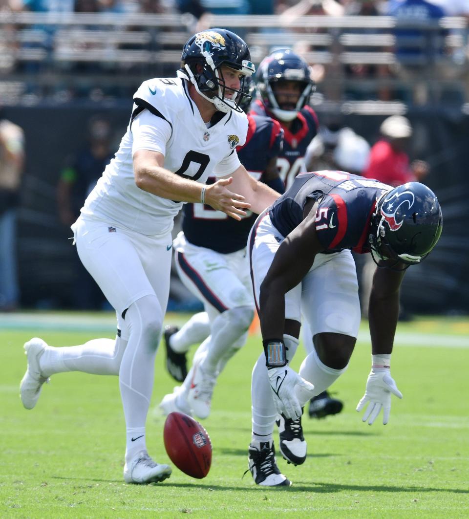 Jacksonville Jaguars punter Logan Cooke (9) and Houston Texans defensive end Will Anderson Jr. (51) tangle as they try to recover a field goal attempt during second quarter action. Houston Texans defensive end Will Anderson Jr. (51) blocked the Jaguars' attempt and the Houston Texans recovered the loose ball. The Jacksonville Jaguars hosted the Houston Texans at EverBank Stadium in Jacksonville, Fla. Sunday, September 24, 2023. The Jaguars trailed 17 to 0 at the end of the first half. [Bob Self/Florida Times-Union]