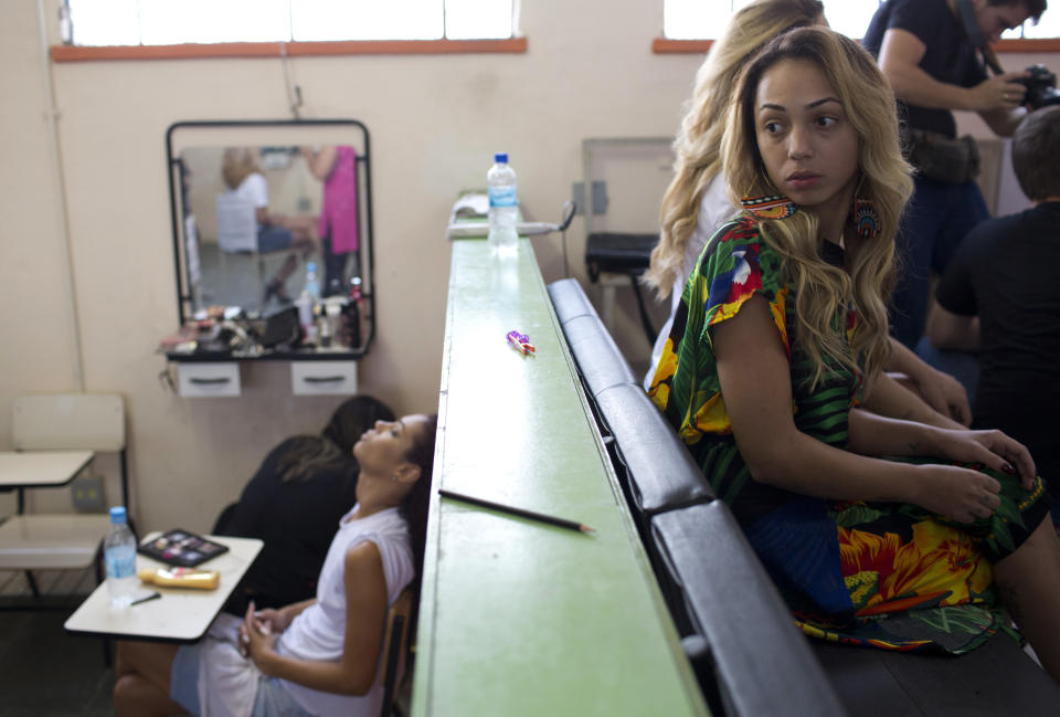 Inmates wait to have their hair styled and make up done to compete in the 13th annual Miss Talavera Bruce beauty pageant at the penitentiary the pageant is named for, in Rio de Janeiro, Brazil, Tuesday, Dec. 4, 2018. Hairdressers and makeup artists volunteer their time to ready the contestants who are judged on their beauty, appeal and attitude. (AP Photo/Silvia Izquierdo)