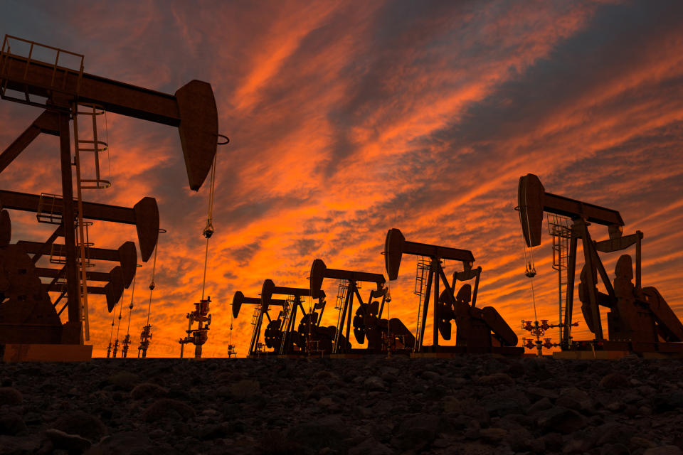 Drilling rigs at sunset.