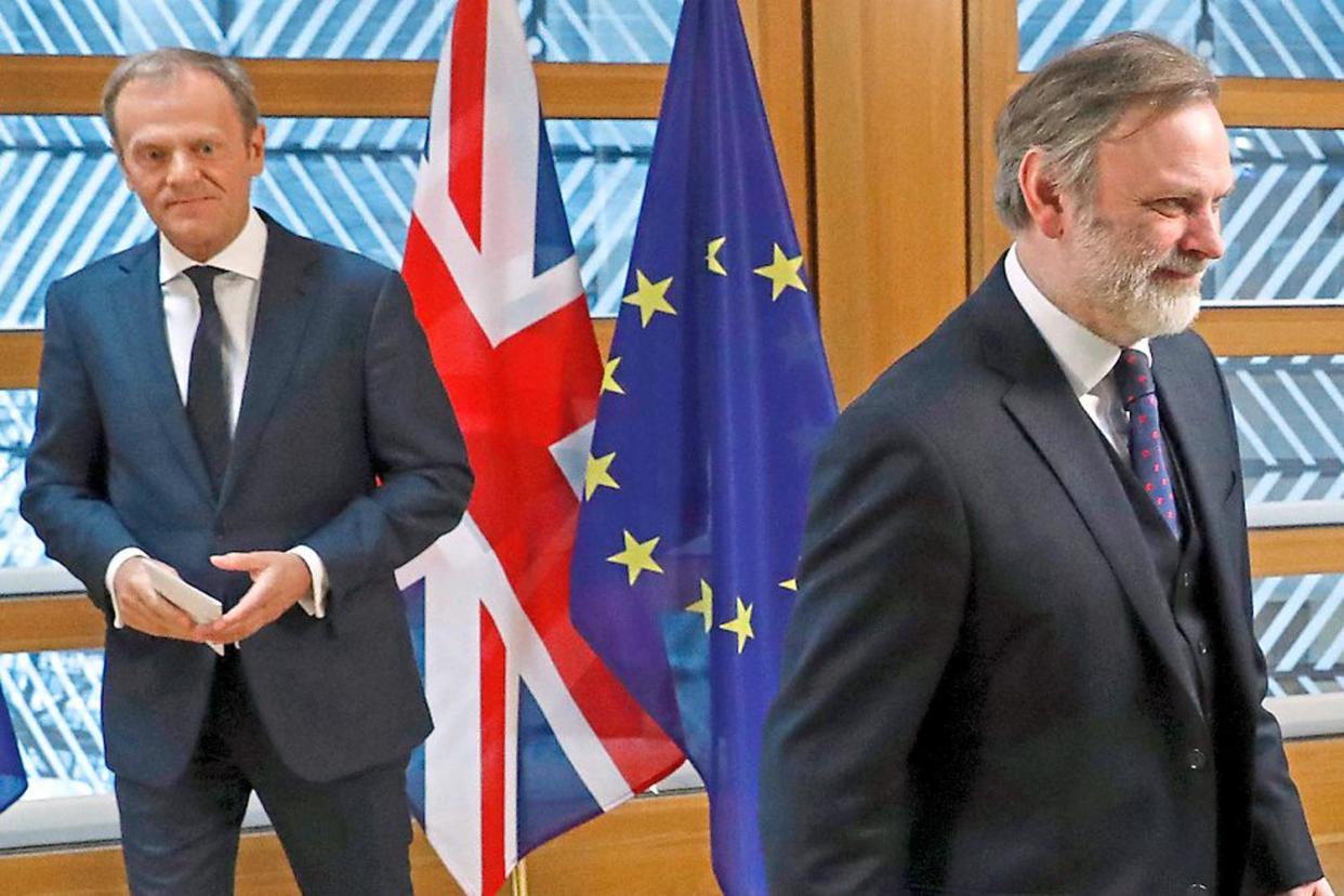 Special delivery: the UK's EU representative Tim Barrow walks away from EU Council President Donald Tusk: AP