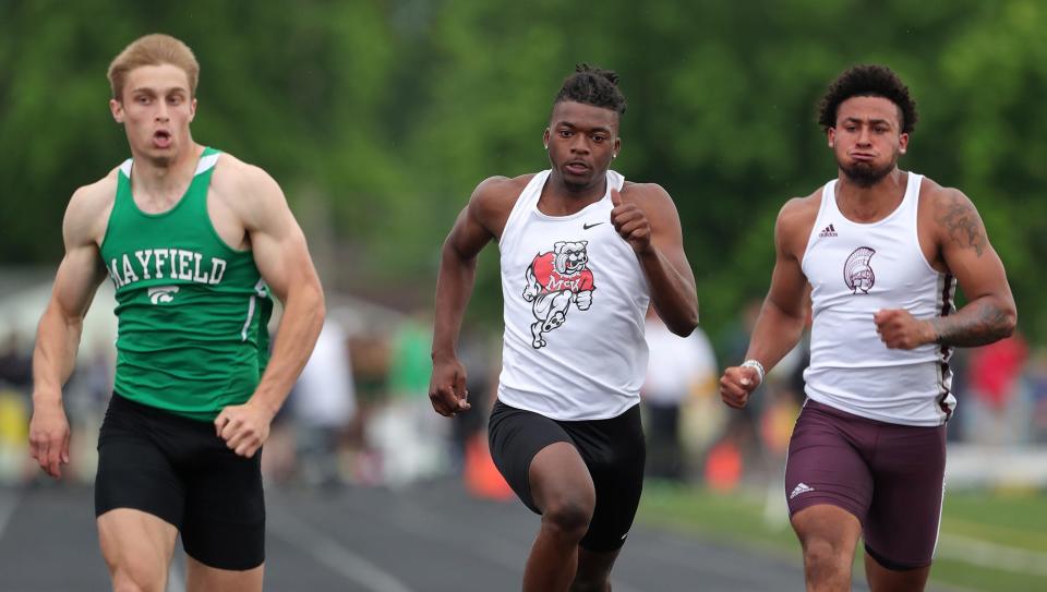 McKinley's Caleb Ruffin, center, competes in the boys 100 meters during the Division I regional track and field meet at Fitch High School on Friday.