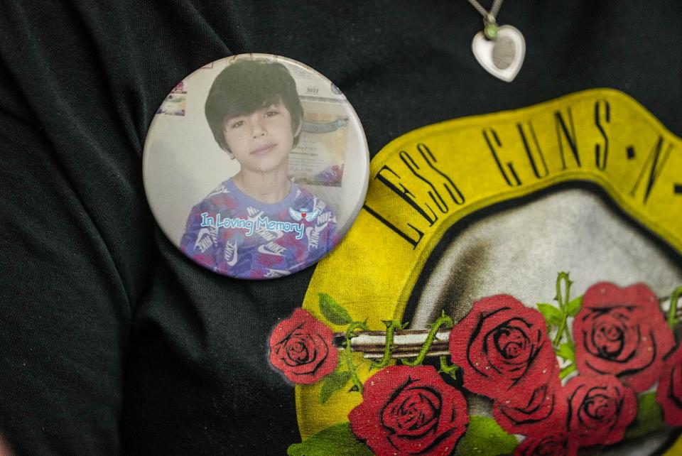 Nicole Cross wears a pin with a photo of Uziyah “Uzi” Garcia of Robb Elementary Thursday, April 27, 2023, while speaking with State Senator Roland Gutierrez at the Texas State Capitol.