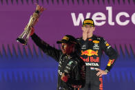 Mercedes driver Lewis Hamilton of Britain celebrates winning the Formula One Saudi Arabian Grand Prix in front of the second placed Red Bull driver Max Verstappen of the Netherlands, in Jiddah, Sunday, Dec. 5, 2021. (AP Photo/Hassan Ammar)