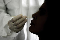 FILE - In this Sept. 19, 2020 file photo, a doctor takes a nasal swab sample to test for COVID-19 at the Cocodrilos Sports Park in Caracas, Venezuela. PAHO, the regional office for the World Health Organization in the Americas, said the week of Jan. 22 2021 that only 3,000, or about 1%, of the 340,000 COVID antigen testing kits sent to the country have been used. (AP Photo/Matias Delacroix, File)