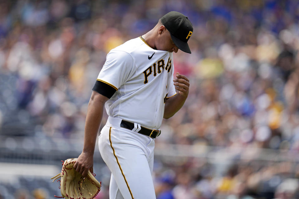 Pittsburgh Pirates starting pitcher Johan Oviedo walks to the dugout out after giving up three runs in the first inning of a baseball game against the Texas Rangers in Pittsburgh, Wednesday, May 24, 2023. (AP Photo/Gene J. Puskar)