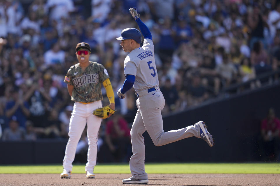 Los Angeles Dodgers' Freddie Freeman celebrates after hitting a three-run home run during the second inning of a baseball game against the San Diego Padres, Sunday, Aug. 6, 2023, in San Diego. (AP Photo/Gregory Bull)