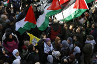 FILE - This Friday, Jan. 31, 2020 file photo, Palestinians chant slogans as they hold Palestinian flags, during a protest against the White House plan for ending the Israeli-Palestinian conflict, at Burj al-Barajneh refugee camp, south of Beirut, Lebanon. The financial crisis that the U.N. agency for Palestinian refugees is experiencing could lead to ceasing some of its activities in what would raise risks of instability in this volatile region, the head of the agency said Wednesday, Sept. 16. (AP Photo/Bilal Hussein, File)