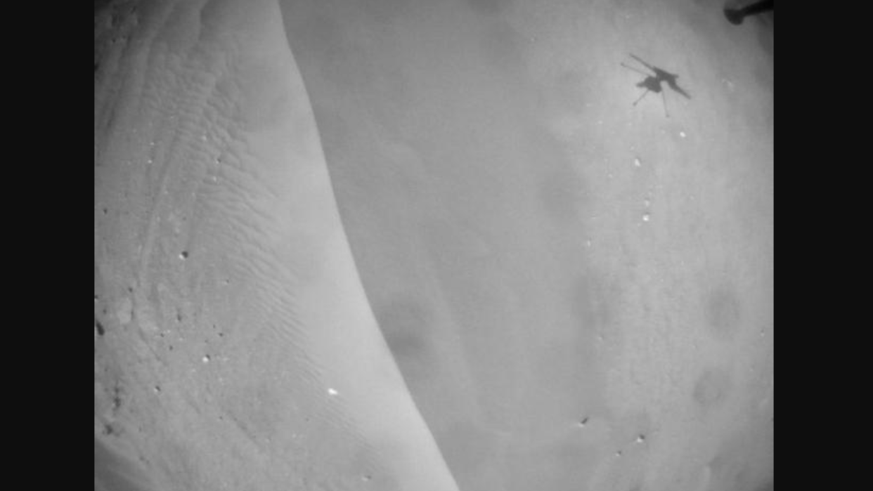  ingenuity helicopter's shadow on the surface of mars in a black and white photo 