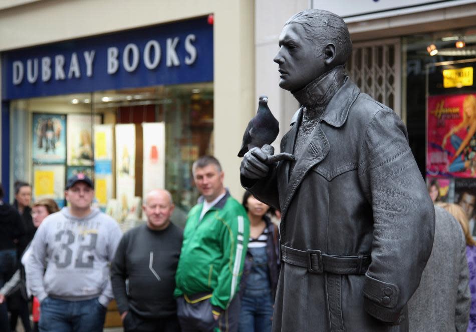 People watch a performance artist in Dublin, Ireland.