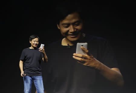 Lei Jun, founder and chief executive officer of China's mobile company Xiaomi Inc, checks the new features of Xiaomi Phone 4 at its launching ceremony in Beijing in this July 22, 2014 file photo. REUTERS/Jason Lee/Files