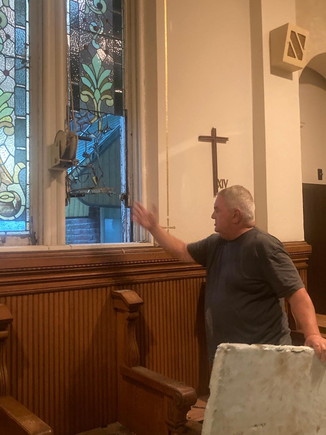 Tony Libri of Preservation, Inc., points to a panel of a stained-glass window broken out in the former chapel used by the Ursuline Sisters. The damage happened last week, Libri said, though he vowed to restore the window to its prominence.