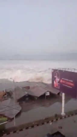 A tsunami wave hits shore in Palu, Indonesia Sulawesi Island, in this September 28, 2018 photo by AMAS. AMAS/Social Media/via REUTERS