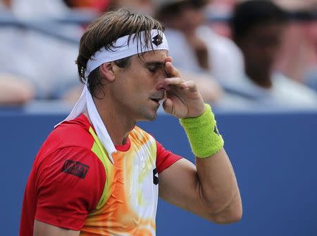 David Ferrer of Spain reacts after a missed return to Gilles Simon of France during their match at the 2014 U.S. Open tennis tournament in New York, August 31, 2014. REUTERS/Eduardo Munoz