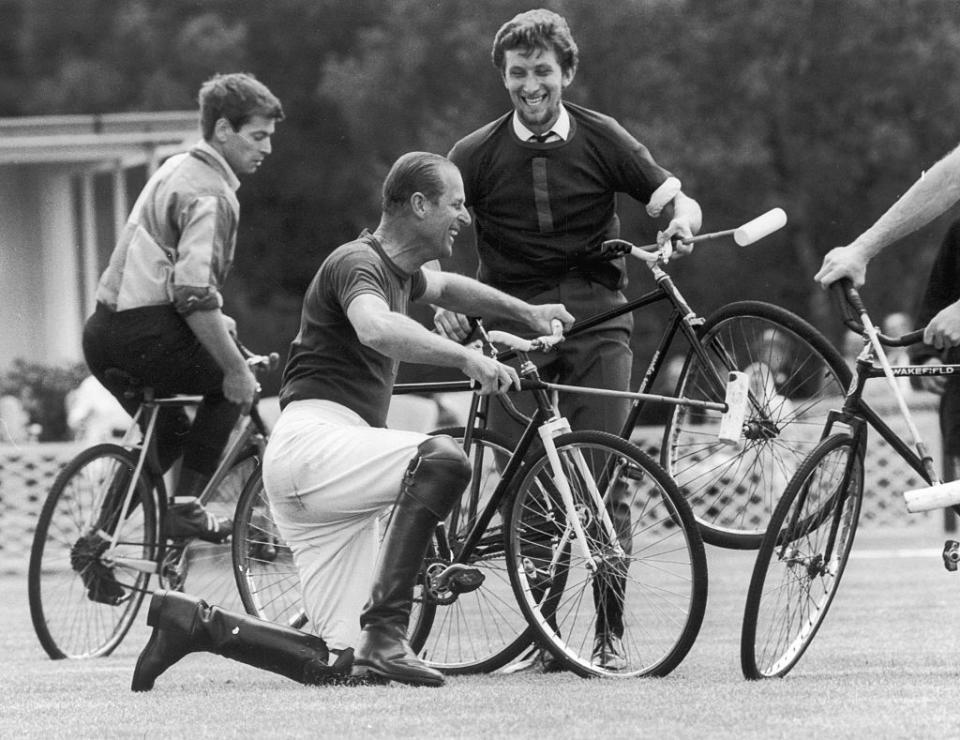 <p>After colliding with a teammate, Prince Philip falls off his bicycle during an attempt at bicycle polo. </p>