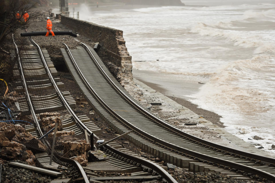 A huge length of railway track is exposed and left hanging after the sea wall collapsed in Dawlish, England where high tides and strong winds have created havoc in the Devonshire town disrupting road and rail networks and damaging property, Wednesday, Feb. 5, 2014. Heavy rain, high tides and strong winds pounded England’s southern coast Wednesday, washing away a stretch of rail line, damaging an iconic seaside pier and leaving thousands of homes without power. (AP Photo/PA, Ben Birchall) UNITED KINGDOM OUT, NO SALES, NO ARCHIVE