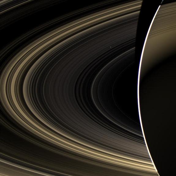 Venus appears as a bright dot shining through Saturn's rings in this image, taken on Nov. 10, 2012, by NASA's Cassini spacecraft. Cassini was about 498,000 miles from the ringed planet at the time.