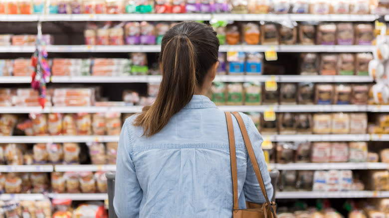 Woman staring at grocery shelves
