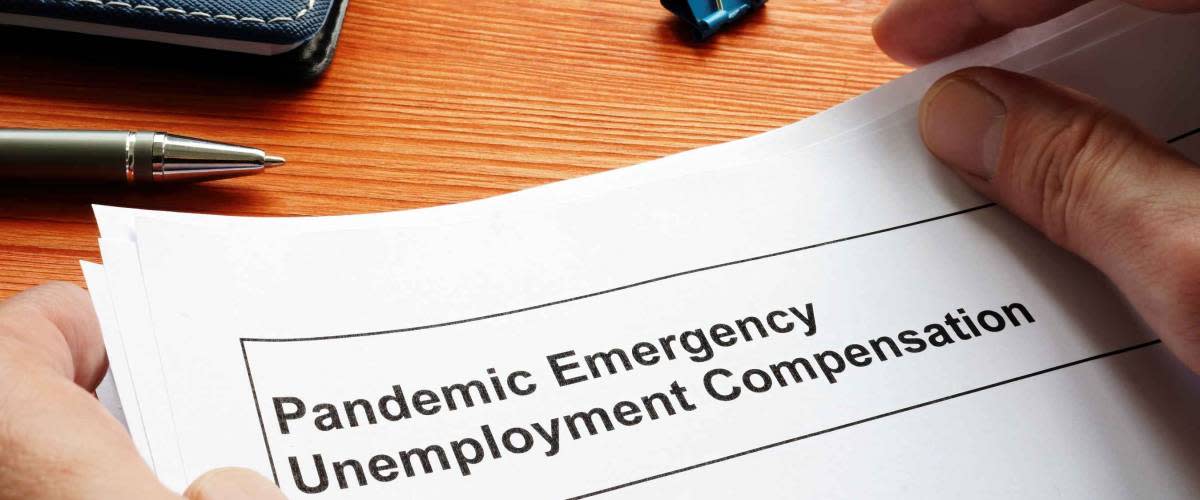 Man holds Federal Pandemic Unemployment Compensation FPUC documents.