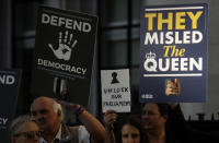 Protesters hold banners outside the Supreme Court in London, Tuesday Sept. 17, 2019. The Supreme Court is set to decide whether Prime Minister Boris Johnson broke the law when he suspended Parliament on Sept. 9, sending lawmakers home until Oct. 14 — just over two weeks before the U.K. is due to leave the European Union. (AP Photo/Matt Dunham)