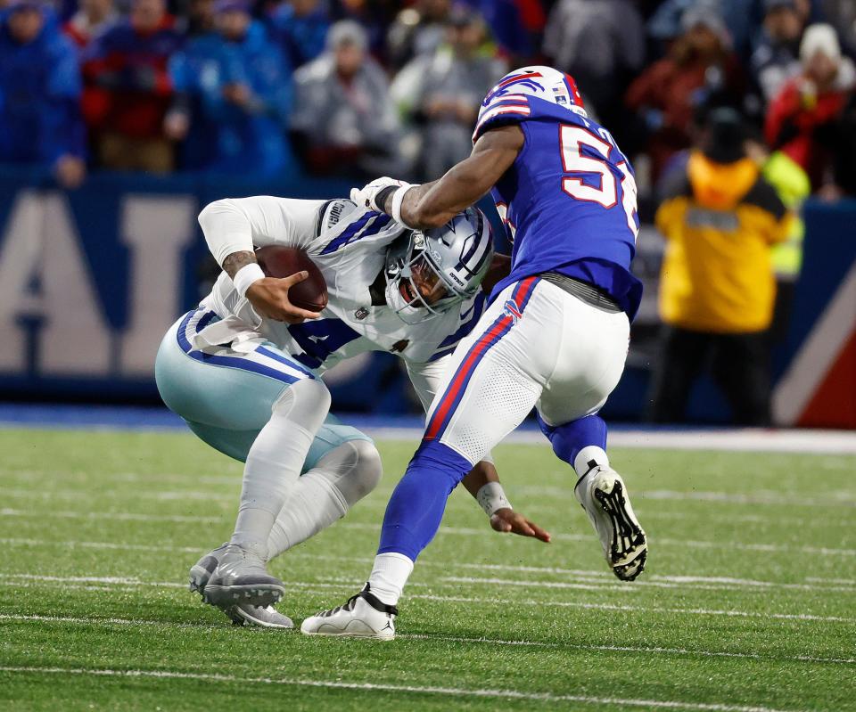 Dallas Cowboys quarterback Dak Prescott (4) is sacked by Buffalo Bills defensive end Greg Rousseau (50). Prescott was pressured much of the game and sacked 3 times in 31-10 Bills win.