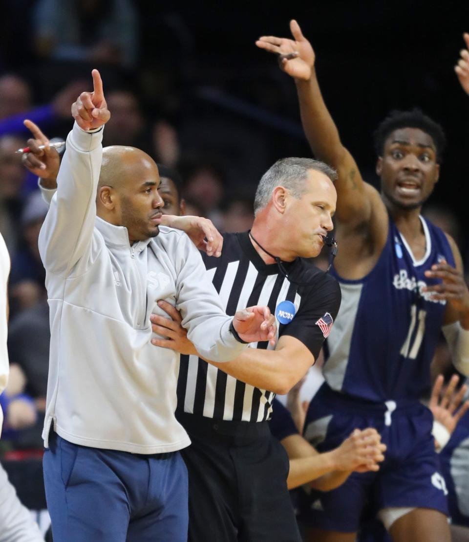 Saint Peter's head coach Shaheen Holloway and KC Ndefo against Purdue