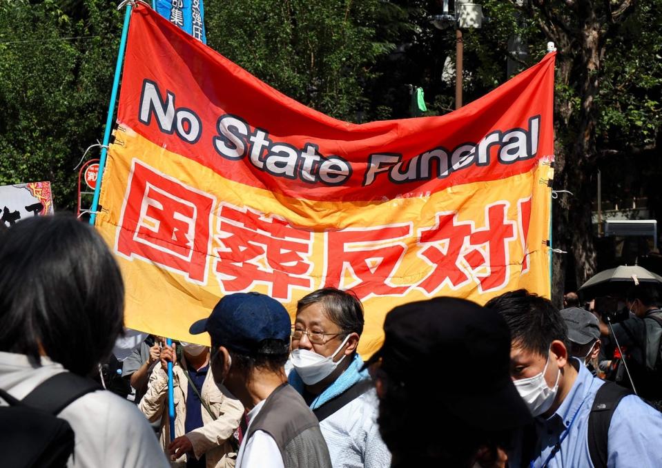 Protesters in Tokyo hold a banner opposing the state funeral (AFP via Getty Images)