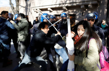 Riot police scuffle with protesters trying to march to the Turkish Parliament to protest against a proposal that would have allowed sentencing in cases of sexual abuse committed "without force, threat or trick" before Nov. 16, 2016 to be indefinitely postponed if the perpetrator marries the victim, in Ankara, Turkey, November 22, 2016. REUTERS/Umit Bektas