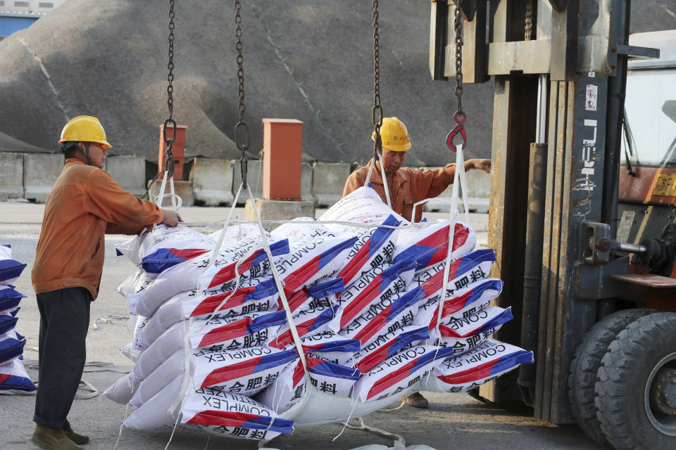 Workers load fertilizer imported from Russia at a port in Nantong in eastern China's Jiangsu Province, Sept. 24, 2018. China is the only friend that might help Russia blunt the impact of economic sanctions over its invasion of Ukraine, but President Xi Jinping’s government is giving no sign it might be willing to risk its own access to U.S. and European markets by doing too much. (Chinatopix via AP)