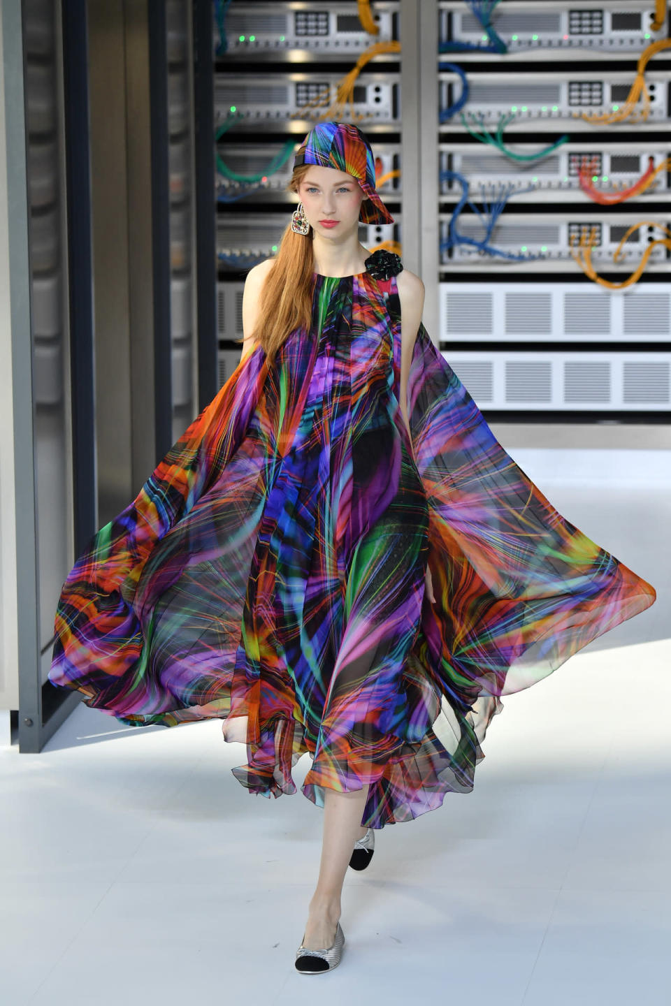 In keeping with the theme of the show, a model sashayed down the runway in a silky sheer dress featuring a colorful collage of digital streams of light. 