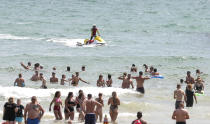 People enjoy the warm weather on Bournemouth beach. Met Office said Friday is the third hottest UK day on record as temperatures reached 37.8C at Heathrow Airport.