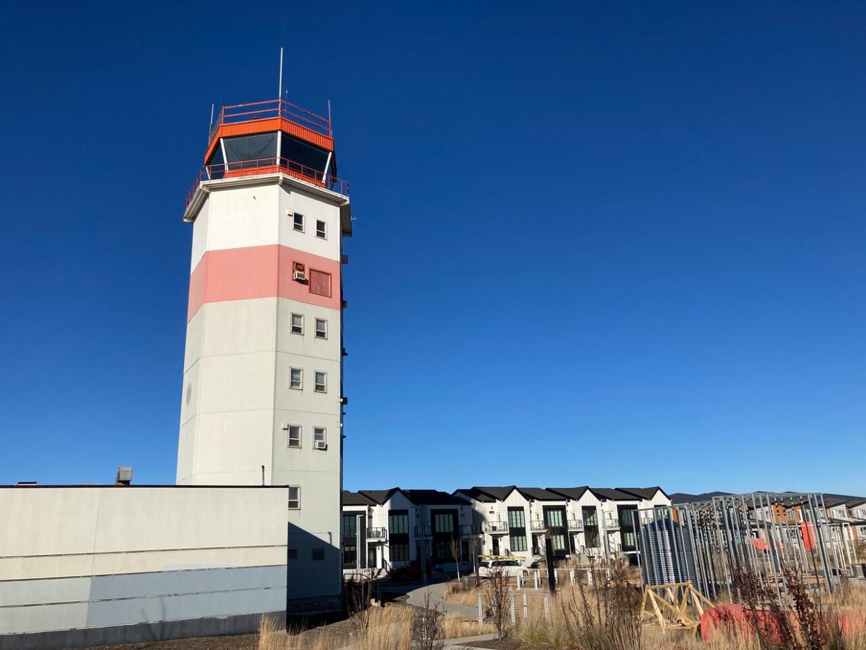 The control tower, left in place after the 2013 closure of Edmonton's City Centre Airport, now stands tall near rows of new homes, some completed and others still under construction. Photographed Nov. 18, 2023. (Dave Howell/CBC - image credit)